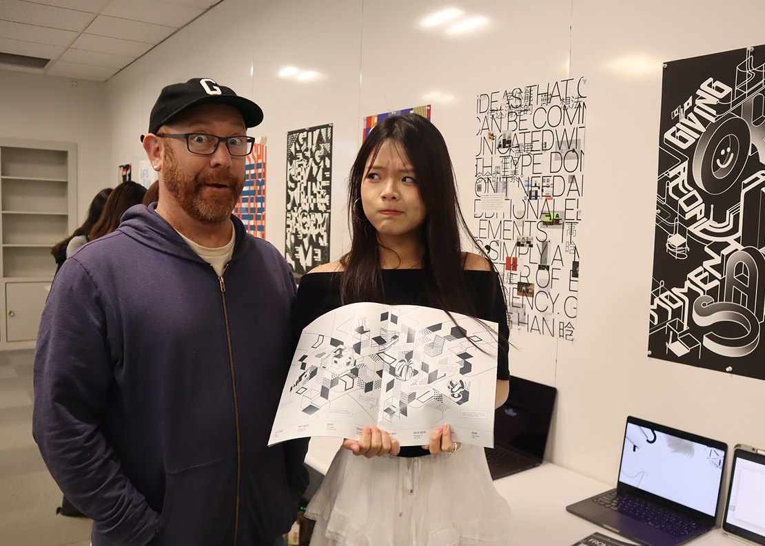 Jean holding a poster at a critique